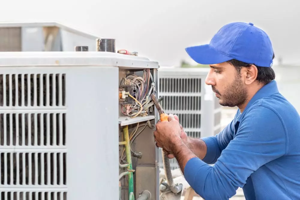 professional ac repair technician working on a unit.jpeg